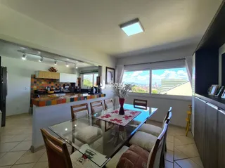 Sala de estar com vista para o exterior e área de jantar.