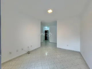 Corredor interno com piso de cerâmica claro e paredes brancas.