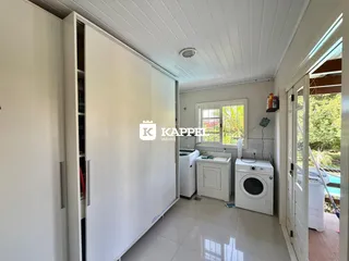 Cozinha com armários brancos e piso de porcelanato.