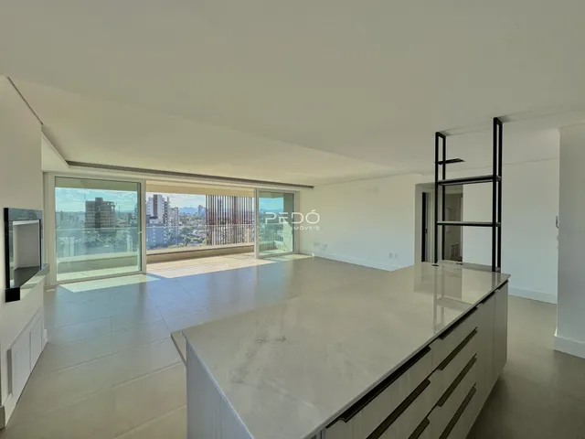 Sala de estar com vista para a cidade através de portas de vidro.