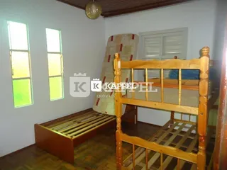 Quarto com cama de madeira e piso de madeira.