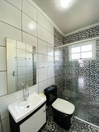 Foto de um banheiro com revestimento de azulejos brancos e pretos.