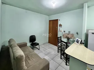 Foto de uma sala de estar com sofá e piso de cerâmica em um imóvel em Lajeado.