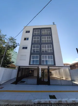 Fachada de um prédio residencial moderno em Lajeado, Brasil, com janelas em caixilhos escuros.