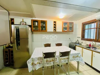 Foto de um interior de sala de jantar com armários e geladeira.
