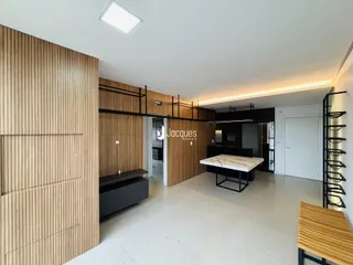 Interior de uma sala de estar moderna com painéis de madeira e piso claro.