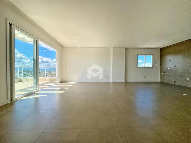 Sala ampla com grandes janelas de vidro que dão para a vista.