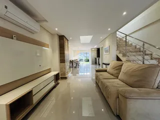 Sala de estar moderna com sofá e piso de cerâmica em um imóvel em Lajeado.