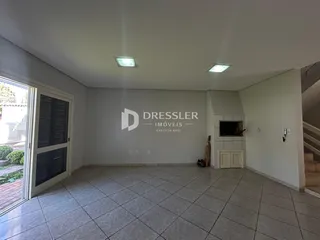 Interior de uma sala com piso de cerâmica e paredes brancas.