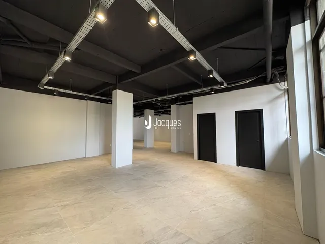 Espaço interno amplo com paredes brancas e piso claro.