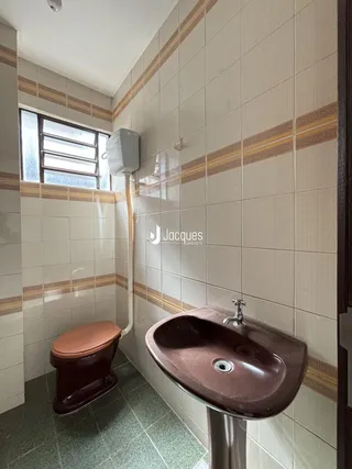 Banheiro com revestimento de azulejos nas paredes e piso.