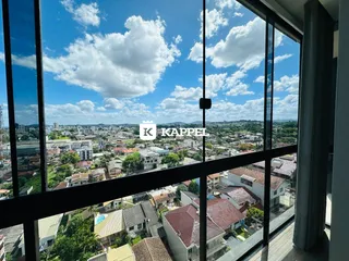 Vista panorâmica da paisagem urbana de Lajeado com céu azul e nuvens.