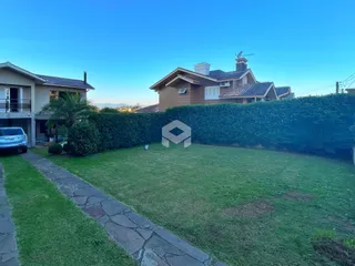 Fachada de uma casa em Lajeado com jardim e cerca viva.