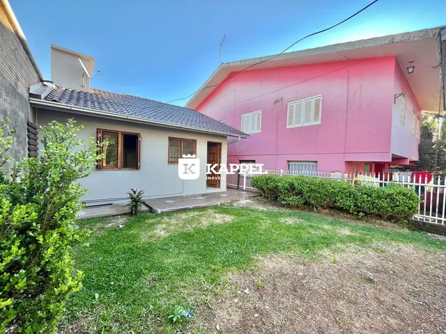 Fachada de uma residência em Lajeado, Brasil, com um jardim gramado em primeiro plano.