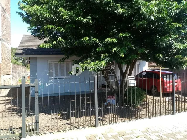 Fachada de uma casa em Lajeado, Brasil, com cerca e vegetação na frente.