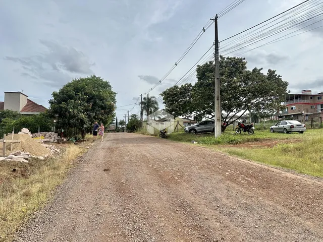 Vista de uma estrada de terra em uma área residencial no Brasil.