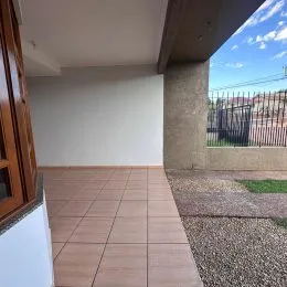 Foto de um piso de madeira em um ambiente interno com parede branca.