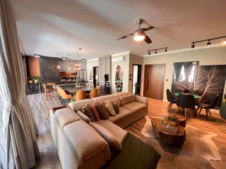 Sala de estar com sofá e área de jantar em um imóvel no Brasil.