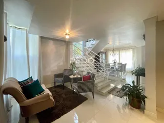 Sala de estar com decoração e acesso a uma escadaria.