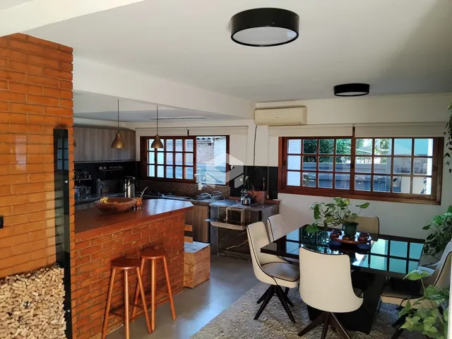Foto de uma cozinha aberta com bancada e mesa de jantar em um imóvel.