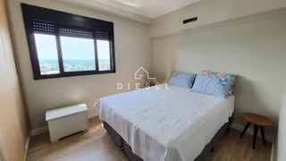 Quarto com grande janela oferecendo vista externa.