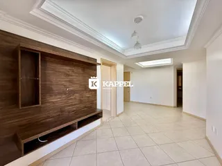 Hall de entrada com painel de madeira e piso claro.