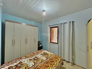 Quarto com armário e cama em ambiente claro.