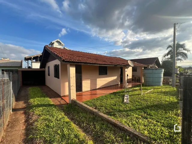 Fachada de uma casa em Lajeado, Brasil, com cerca e jardim gramado.
