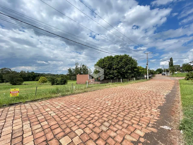 Vista da rua pavimentada com gramado e cerca em Lajeado, Brasil.