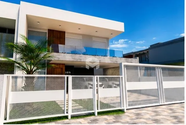 Fachada moderna de uma residência em Lajeado, Brasil, com portão branco.