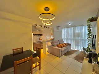 Sala de estar com decoração moderna e grandes janelas em um imóvel no Brasil.