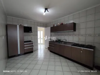 Foto de uma cozinha com armários de madeira e piso cerâmico.
