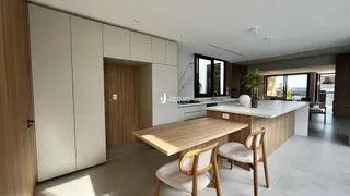 Ambiente moderno com armários embutidos e mesa de madeira em uma sala de estar.