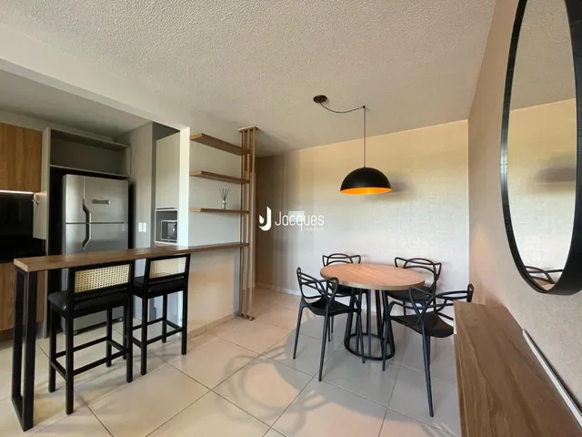 Ambiente interno com mesa de jantar e bancada na residência.