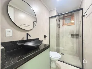 O interior de um banheiro moderno com box de vidro.