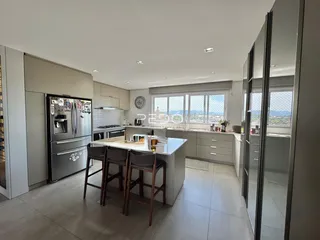 Vista da cozinha moderna com ilha e janelas em Lajeado, Brasil.