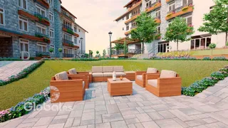 Vista externa de um condomínio residencial com área de lazer e jardim.