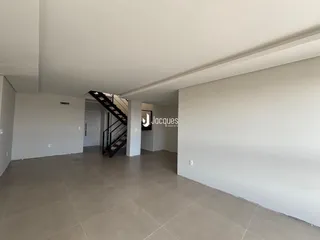 Hall de entrada com piso de cerâmica e escadaria em um imóvel em Lajeado.