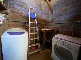 Foto de um ambiente interno com paredes de tijolos aparentes e eletrodomésticos.