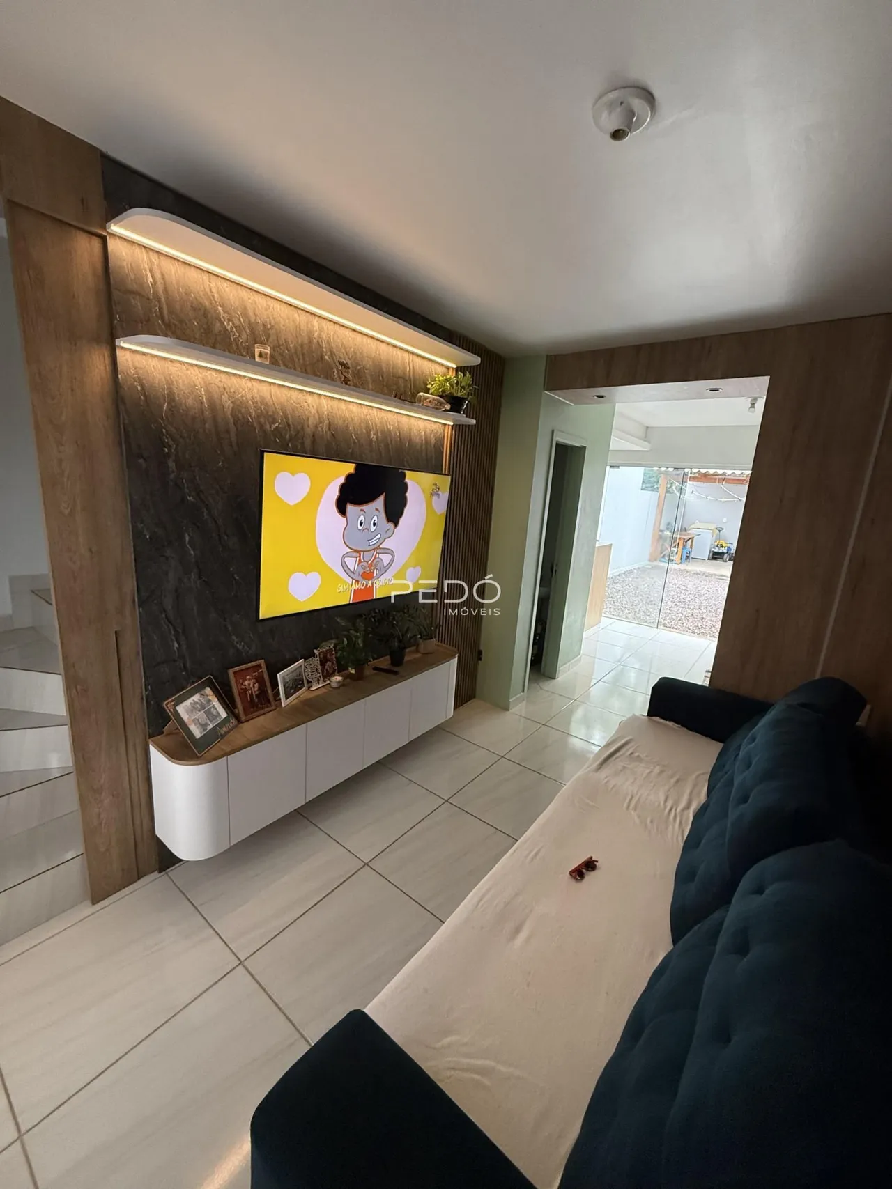 Sala de estar com parede de destaque e móveis modernos.