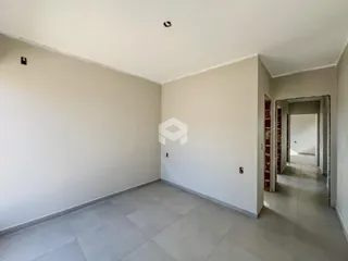 Hall de entrada com paredes brancas e piso de cerâmica.