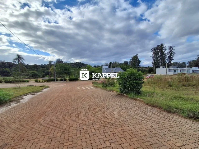 Vista externa da propriedade mostrando uma estrada pavimentada e vegetação ao fundo.