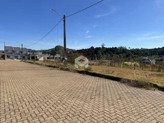 Vista externa de uma propriedade em Lajeado, Brasil, com paisagem de vegetação seca ao fundo.