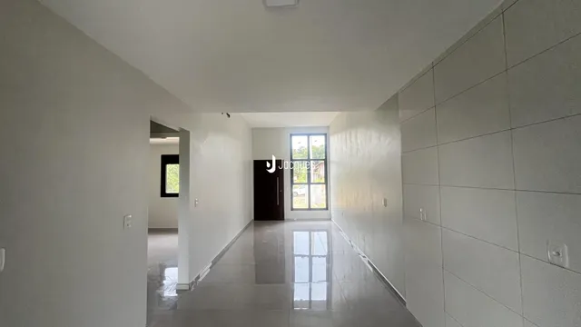 Corredor interno de uma residência com piso de cerâmica.