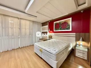 Quarto com cama grande e paredes vermelhas em Lajeado.