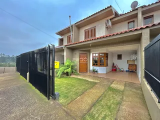 Fachada de uma casa em Lajeado, Brasil, com cerca e jardim frontal.