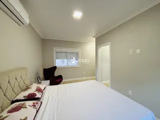 Quarto com cama e janela em ambiente interno.