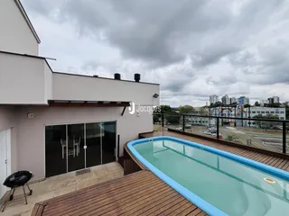 Vista da área externa com piscina e deck de madeira de uma residência em Lajeado.