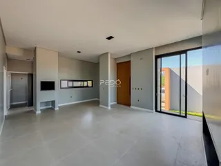 Sala de estar ampla com piso claro e paredes cinzas.