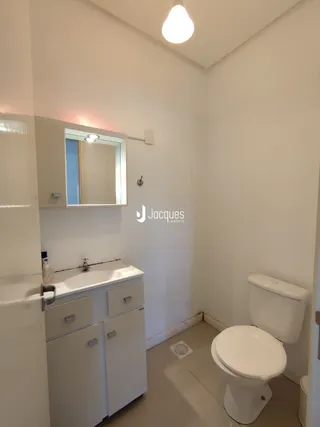 Foto de um banheiro interno com pia e vaso sanitário.